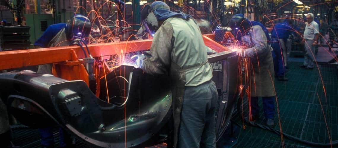 Des ouvriers qui travaillent dans une industrie automobile avec une certification TISAX