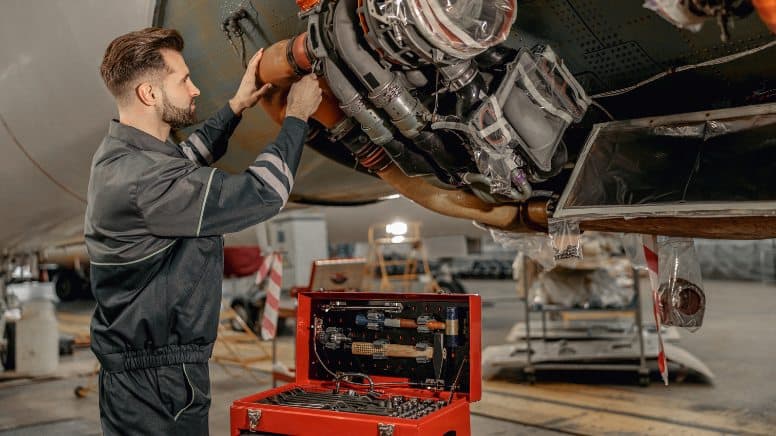Un technicien qui assure la maintenance d'un avion
